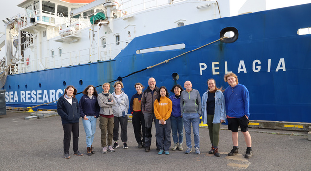 The picture shows a group of Microbial Oceanography Lab members together with collaborators infront of the RV Pelagia. 