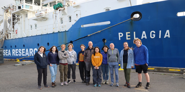 The picture shows a group of Microbial Oceanography Lab members together with collaborators infront of the RV Pelagia. 